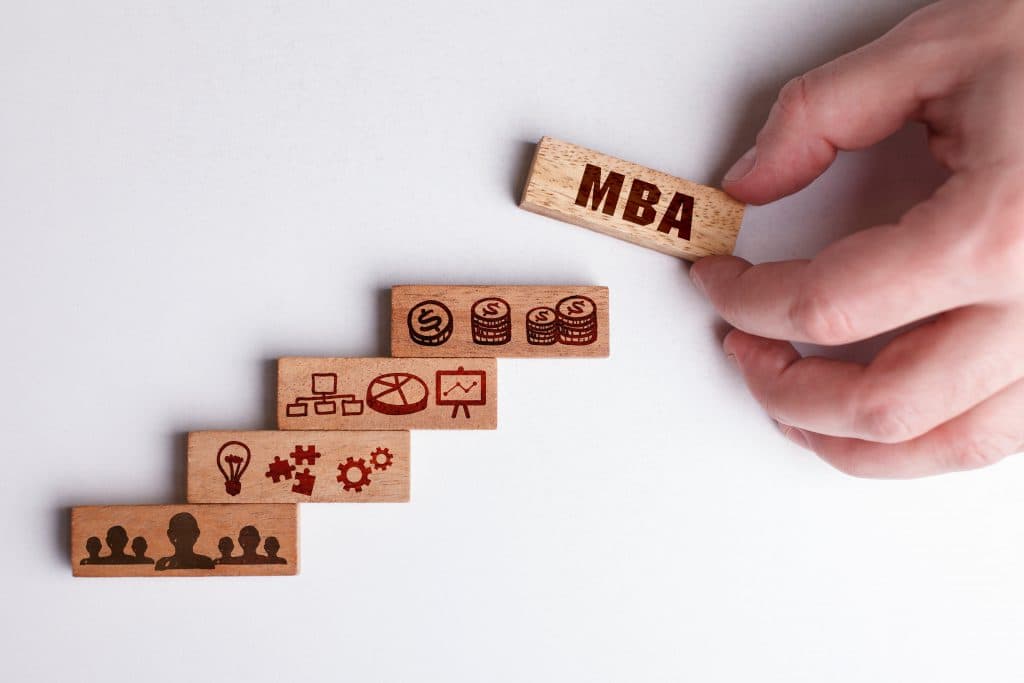 Wooden blocks stacked as steps leading up to a block labelled MBA